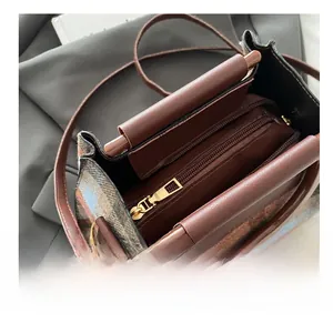 Close-up of retro plaid woolen tote bag featuring smooth metal zipper and leather strap