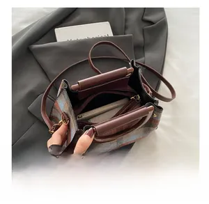 Interior view showing the spacious compartments and lining of the plaid crossbody bag