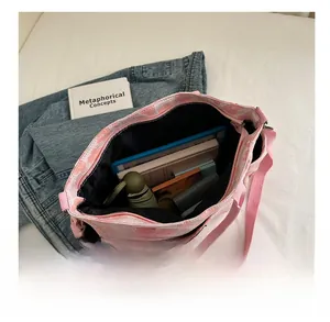Internal capacity view of pink floral canvas tote bag holding tablet and daily items