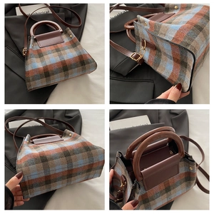Detail of vintage plaid wool tote bag showing texture, metal hooks and brown PU handles