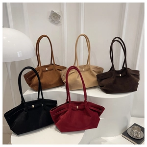 Minimalist matte tote bags in five colors displayed on elegant white pedestal