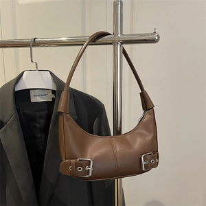 Chic brown leather crescent hobo bag with vintage buckle straps and shoulder strap