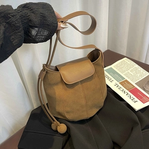 Brown frosted suede bucket bag with drawstring closure and stylish leather shoulder strap
