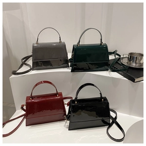 Detailed display of vintage glossy patent leather handbags in four elegant classic colors