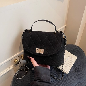 Luxury black quilted chain crossbody bag with gold twist lock and elegant top handle