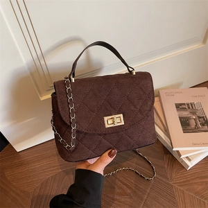 Quilted dark brown crossbody bag with gold chain strap and textured diamond pattern