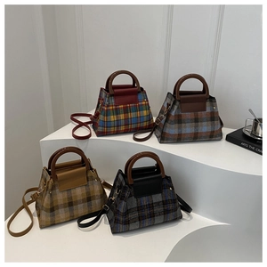 Detail view of retro plaid crossbody bags with round handles in four color options