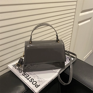 Vintage dark grey glossy trapezoid crossbody bag with gold metal hardware details