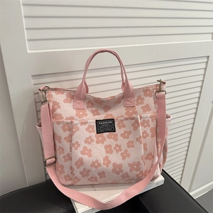 Pink floral canvas tote bag with adjustable shoulder strap and side pocket for daily use
