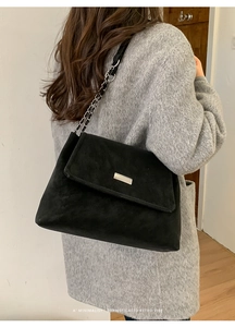 Model view of black suede chain shoulder bag with silver hardware for casual commute