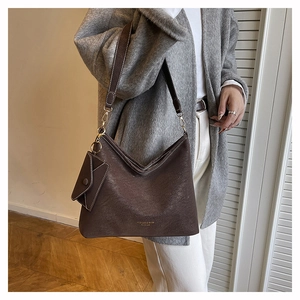 Détail du sac cabas vintage marron foncé avec lettrage doré et petite pochette attachée