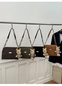 Detail view of four minimalist flap shoulder bags in matte leather with cute rabbit charms