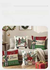 Set of four Christmas pillow covers with festive prints on a modern grey sofa