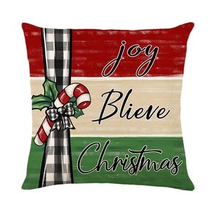 Christmas pillow cover with red and white festive patterns and holiday text on white background