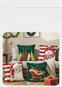 Detail of Christmas pillow covers featuring Santa and reindeer on a gray sofa