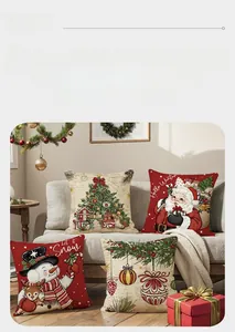Detailed view of four Christmas pillow covers with Santa and snowman prints on a sofa