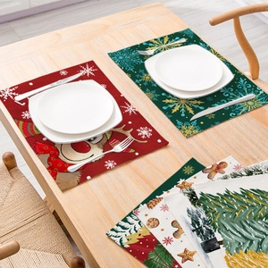 Linen cotton Christmas placemats with festive elk and snowflake patterns on a wooden table