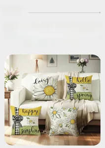 Detailed view of four spring daisy pillow covers with floral patterns on white sofa