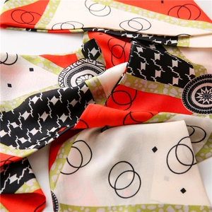 Satin silk neck scarf with houndstooth and star patterns in red, green and black