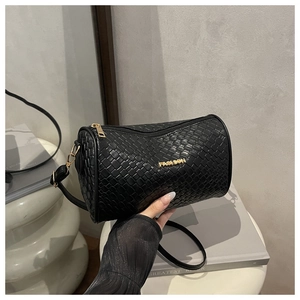 Détail du sac Boston à texture tressée noire avec logo Fashion en métal doré et zip