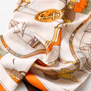 Detail of nautical anchor print silk scarf with satin luster in orange and cream