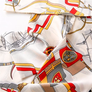 Detailed close-up of nautical anchor and sailboat print on a silky narrow scarf