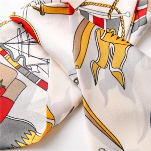 Close-up of anchor chain print on sleek satin silk scarf with nautic rope patterns