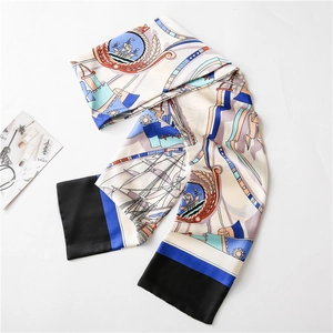 Macro detail of nautical silk scarf featuring navy anchor chains and sailboat patterns