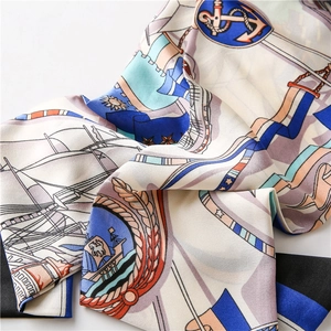 Detailed view of the nautical anchor silk scarf with navy blue and cream marine prints