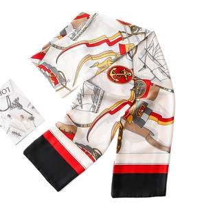 Elegant nautical silk scarf with anchor prints and red border in a flat lay view