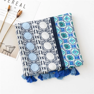 Detail of multi-colored printed scarf with fringe tassels and ethnic patterns