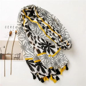 Detail of floral polka dot scarf with yellow stripes and bicolor tassels on white background