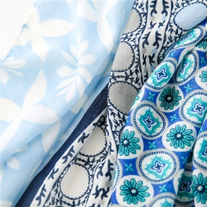Close-up of lightweight tricolor scarf showing blue and grey floral vine patterns