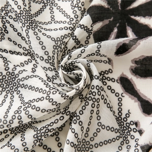 Detail of floral and polka dot printed scarf with soft cotton-linen texture and drape