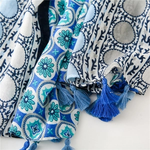 Detailed view of tricolor cotton-linen scarf with floral prints and fringe tassels