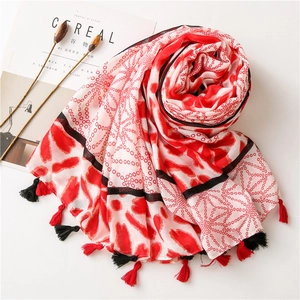 Detail of red and white polka dot scarf with fringes and cotton linen texture