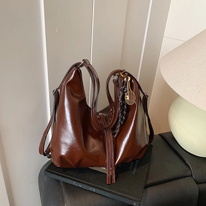 Vintage dark brown faux leather Boston bag with a unique gold tennis racket pendant charm