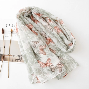 Floral and butterfly print lightweight scarf with soft linen feel on white background