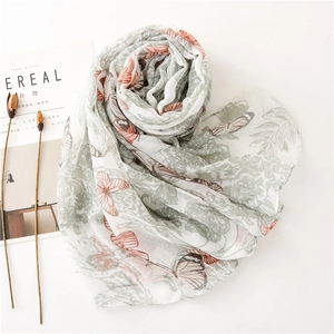 Detail of floral butterfly print on lightweight breathable cotton-linen feel scarf