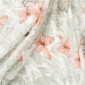 Detail of floral butterfly print on lightweight cotton linen scarf with soft folds