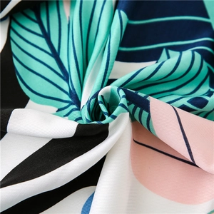 Tropical leaf and geometric print beach shawl with green and pink silk texture