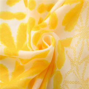 Detailed macro view of yellow and white floral polka dot cotton linen fabric texture