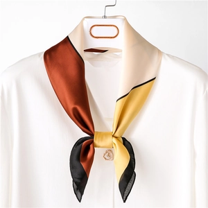 Elegant geometric color-block silk neck scarf tied on white shirt for spring styling