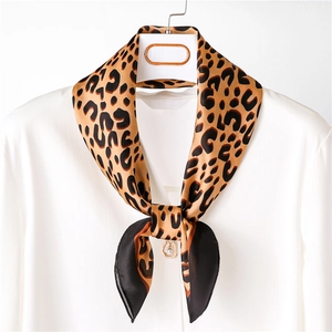 Classic leopard print silk square scarf tied on a white shirt collar for office wear