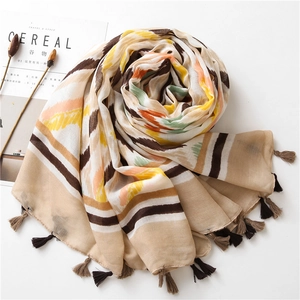 Detail of colorful kaleidoscope pattern cotton linen scarf with soft fringe tassels
