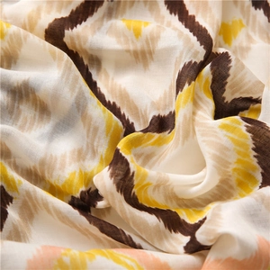 Close-up of bohemian style cotton linen scarf showing colorful geometric wave patterns