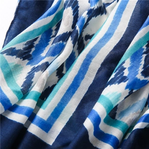 Detail of bohemian scarf showing blue Ikat patterns and textured cotton linen weave