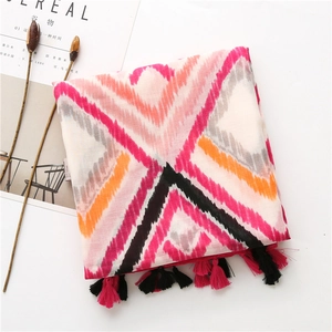 Detail of bohemian scarf showing colorful geometric zigzag pattern and tassel fringe