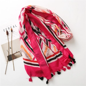 Detail of bohemian cotton linen shawl featuring colorful kaleidoscope print and soft tassels