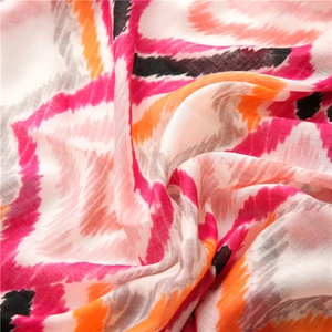 Detailed close-up of bohemian ikat patterned scarf featuring vibrant zigzag weave textures